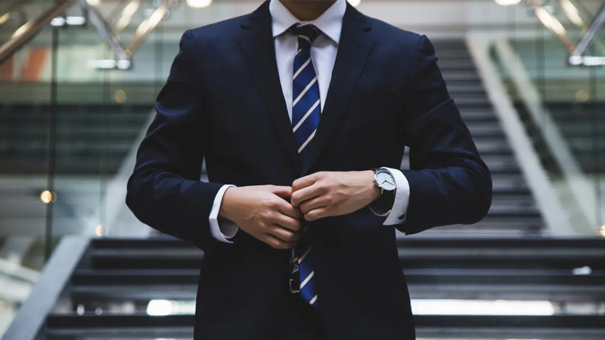 Man buttoning his suit jacket to represent the Appointments Commission